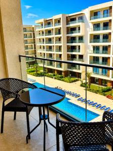 a balcony with a table and chairs and a pool at Sea Breeze Apartments in Baku