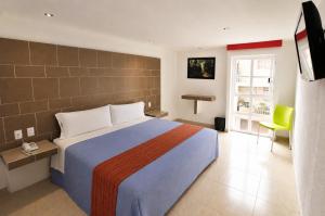 Postel nebo postele na pokoji v ubytování First Inn Hotel & Business
