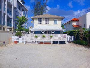 a white house with a white fence in front of it at Annabelle's in Saint James