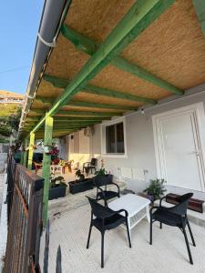 a patio with a table and chairs on a patio at Lukova rooms in Lukovë