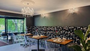 a dining room with tables and chairs and a chandelier at Patcham Place, Clarens in Clarens