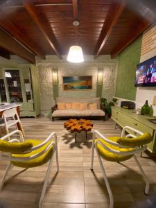 a living room with two chairs and a couch at Talita Cumi in Villa Santa Cruz del Lago +7 photos