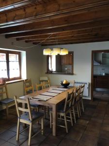 a kitchen and dining room with a wooden table and chairs at Bellver-Baltarga in Bellver de Cerdanya