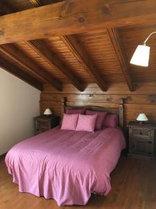 a bedroom with a purple bed with two night stands at Bellver-Baltarga in Bellver de Cerdanya