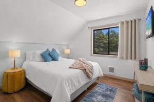a white bedroom with a bed and a window at Terimore Lodging by the Sea in Tillamook