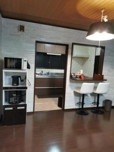 a kitchen with a table and chairs and a microwave at Villa9 in Onjuku
