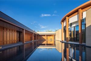 an external view of a building with a swimming pool at Hotel Indigo Nalati by IHG in Narat