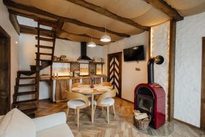a dining room with a table and a wood stove at Villa Pelahia in Slavske