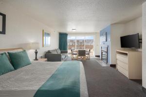 a hotel room with a bed and a living room at Surfside Resort in Rockaway Beach