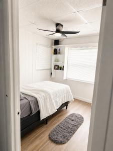 a bedroom with a bed and a ceiling fan at The orlando oasis in Orlando