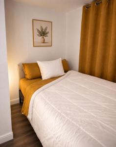 a bedroom with a large bed with a yellow blanket at The orlando oasis in Orlando