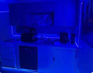 a kitchen with blue lighting in a dark room at The orlando oasis in Orlando