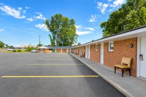 an empty parking lot next to a brick building at Rocky Mount Motel near Hwy 220 in Rocky Mount