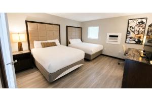 a hotel room with two beds and a desk at Rocky Mount Motel near Hwy 220 in Rocky Mount