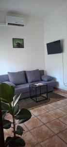 a living room with a couch and a table at SIM residence in Maniago