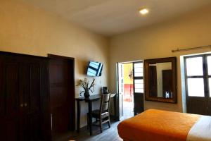 a bedroom with a bed and a table and a mirror at Balcones de Galarza 24 in Guanajuato +51 photos