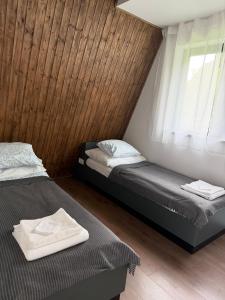 two beds in a room with a window at Domašovo in Holčíkovce +37 photos
