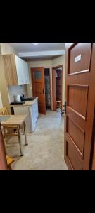 a kitchen with a door open to a kitchen with a table at Gościniec Joanna in Rajgród