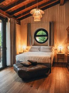 a bedroom with a large bed and a window at Ca' Bella Hospitality in Vignole Borbera +27 photos