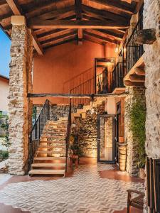 a stone staircase in a house with a stone wall at Ca' Bella Hospitality in Vignole Borbera