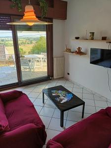 a living room with a couch and a table at Appartamento in villa con vista Monviso in Piossasco