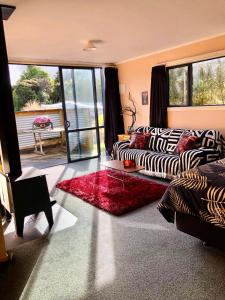 a living room with a zebra couch and a table at The Shed in Manapouri