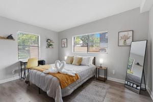 a bedroom with a bed with a towel on it at Amazing 2BR Queen 8mins SODO & 4mins ORMC in Orlando