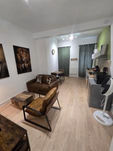 a living room with a couch and a table at Le Club Philibert in Auxerre