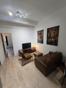 a living room with a couch and a table at Le Club Philibert in Auxerre