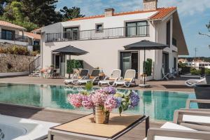 a villa with a swimming pool and a house at Hillside House Residence in Foz do Arelho