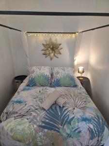 a bed with a flower headboard with lights on it at Le Club Philibert in Auxerre