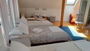 a room with three beds and a chair in it at HOTEL Crystal Lights in Pirot +73 photos