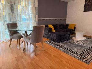 a living room with a glass table and a couch at V hotel in Savigny-le-Temple