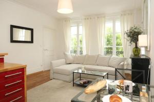 a living room with a white couch and a table at C34-Panorama in Chantilly