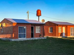 a house with a water tower on top of it at Posada La Martina in Goya
