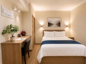 a hotel room with a bed and a desk at Hotel Asia Pacifico in Santiago