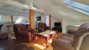 a living room with leather chairs and a table at HOTEL Crystal Lights in Pirot