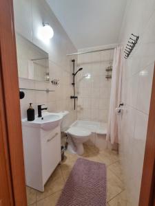 a white bathroom with a sink and a toilet at Gościniec Joanna in Rajgród +63 photos