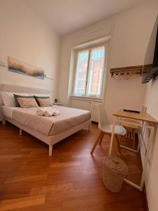 a bedroom with a bed and a desk and a table at 7 CENTRALE Rooms & Suite in Milan