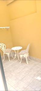a table and two chairs and a table and a table at Life Home in Scilla