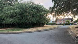 an empty road with trees and a house in the background at Robins nest in Great Hanwood