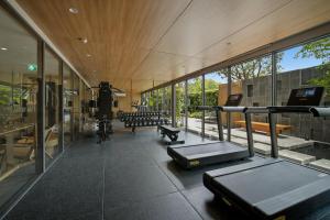 a gym with a lot of windows and some equipment at Seashore Beach Residences by NLA in Bang Tao Beach