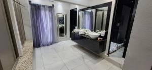 a bathroom with two sinks and a large mirror at Gran Hotel Cantera La plaza in Nuevo Laredo +44 photos