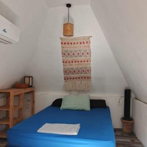 a room with a blue bed in a attic at El Puente in El Paredón Buena Vista +105 photos