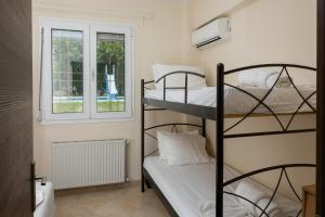 a room with two bunk beds and a window at Zeusplace Anamesa Pool Villa in Litochoro +93 photos