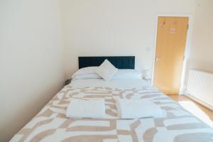 a bedroom with a large bed with two pillows at The Welsh Hideaway in Llanberis +6 photos