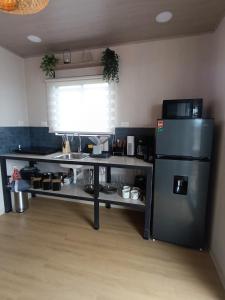 a kitchen with a stainless steel refrigerator and a counter at Alma Libre 01 in Fortuna +7 photos