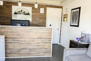a lobby with a wooden wall with a counter at Mountain View Inn Irvine Near Richmond KY in Irvine