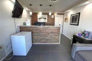 a kitchen with a counter with a bar and a tv at Mountain View Inn Irvine Near Richmond KY in Irvine