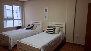 a bedroom with two beds with pillows on them at Depto Libertad 1 in San Francisco